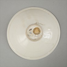 A shallow cream glazed bowl with rolled rim andraised footrim, Tang dynasty, c.800-900. Artist: Unknown.