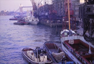 Barges in the Pool of London. River Thames and Tower Bridge, London, 1962. Artist: CM Dixon.