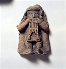 Pottery Figure of Man with Pan Pipes, from Coumbia, Pre Columbian. Artist: Unknown.
