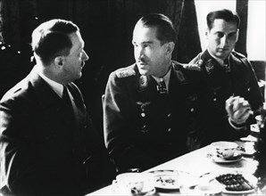 Adolf Hitler in conversation with German air force fighter ace Adolf Galland, 1941. Artist: Unknown
