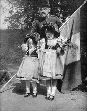 Young Alsatian children in traditional dress with a French soldier, World War I, 1915. Artist: Unknown