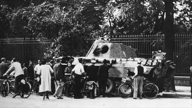 Bystanders examining an abandoned tank on the Rue de Medicis, liberation of Paris, August 1944. Artist: Unknown