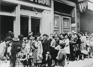 People queuing outside a dairy shop, German-occupied Paris, 26 July 1940. Artist: Unknown