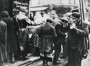 Soup kitchen for the needy, les Halles, German-occupied Paris, February 1941. Artist: Unknown