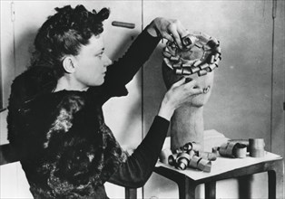 Woman making a hat from wood shavings, German-occupied France, April 1941. Artist: Unknown