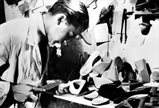 Making wooden shoe soles, German-occupied Paris, February 1941. Artist: Unknown
