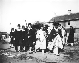 Japanese official with an escort of soldiers, Korea, c1900. Artist: Unknown