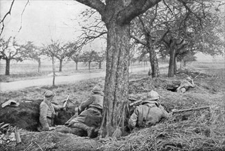 French machine gunners dug in at the edge of a road, under apple trees, 1918. Artist: Unknown