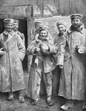 German prisoners of war with their ration of bread, 1915. Artist: Unknown