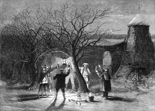 Wassailing apple trees with hot cider in Devonshire on twelfth eve, 1861. Artist: Unknown