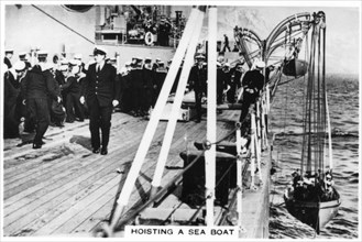 Hoisting a sea boat, HMS 'Nelson', 1937. Artist: Unknown
