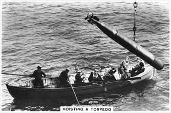 Hoisting a torpedo, HMS 'Courageous', 1937. Artist: Unknown