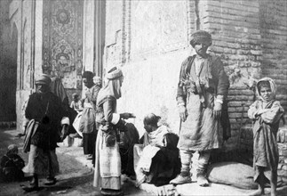 Kurdish barber, outside Kazimain mosque, Iraq, 1917-1919. Artist: Unknown