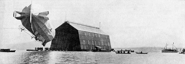 A Zeppelin entering its floating shed, c 1900, (c1920). Artist: Unknown