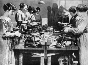 Women cobblers repairing footwear for the war effort, 1914-1918 (1936). Artist: Unknown