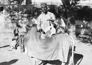 Man with a deformed cow, India, 1916-1917. Artist: Unknown