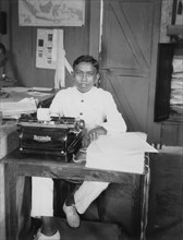 A young man sitting at a typewriter, Indonesia, 20th century. Artist: Unknown