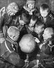 Lapp children looking at a globe, 1936. Artist: Unknown