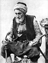 A peasant drinking coffee and smoking a huqqah, Izmir, Turkey, 1936. Artist: Unknown