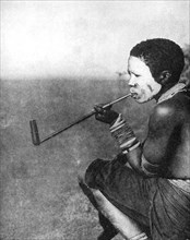 A South African tribesman smoking, 1936.Artist: South African Railways