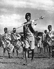 Bandsmen of the Northern Rhodesia Regiment beat a military tattoo, Zimbabwe, Africa, 1936.Artist: LNA Images