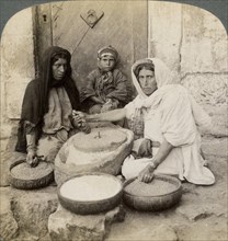 Women grinding at the mill, Palestine, 1900.Artist: Underwood & Underwood