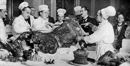 Carving a side of beef at the annual banquet at the Guildhall, London, 1926-1927. Artist: Unknown