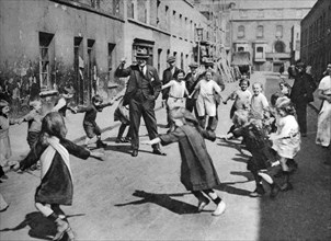 Children dancing in the street, London, 1926-1927. Artist: Unknown
