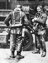 Firefighters donning smoke helmets, Farringdon Street rubber works, London, 1926-1927. Artist: Unknown