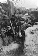 The periscope in use in a French trench, First World War, 1914-1918, (c1920). Artist: Sphere