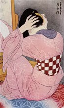 A Japanese woman dressing her hair, 1920s (1930).Artist: Hashiguchi Goyo