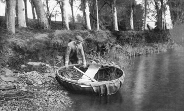 Launching a coracle on the River Boyne, County Meath, Ireland, 1924-1926. Artist: WA Green