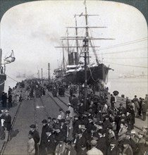 Greetings for newcomers on the pier alongside the Pacific Mail SS 'China, at Yokohama, Japan, 1904.Artist: Underwood & Underwood