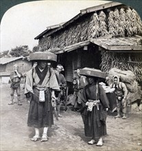 Pilgrim beggars beating little gongs, near Lake Kawaguchi, Japan, 1904. Artist: Underwood & Underwood