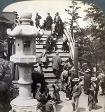 Worshippers crossing the semi-circular bridge to Kameido Temple beyond, looking north, Tokyo, Japan,Artist: Underwood & Underwood