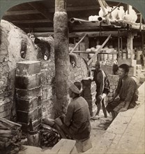 Workmen watching kilns full of Awata porcelain, Kinkosan works, Kyoto, Japan, 1904. Artist: Underwood & Underwood