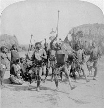 'Heroic sports of the Kraal, a Zulu war dance', Zululand, South Africa, 1901. Artist: Underwood & Underwood