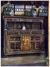 Carved and inlaid oak court cupboard, 1910.Artist: Edwin Foley