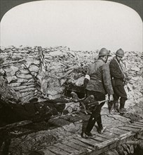 Belgian stretcher bearers carrying wounded in a trench, Dixmude, Belgium, World War I, 1914-1918.Artist: Realistic Travels Publishers