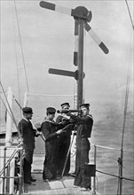 Signalling by semaphore on board HMS 'Camperdown', 1895. Artist: Gregory & Co
