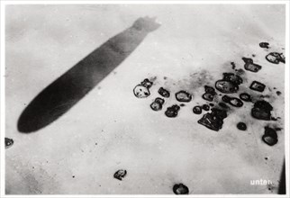 Aerial view of a desert settlement, with a shadow cast by a Zeppelin, 1931 (1933). Artist: Unknown