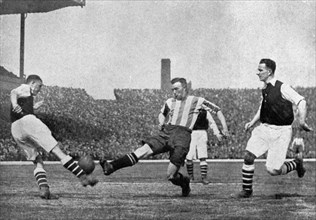 Action from an Arsenal v Sheffield United football match, c1927-1937.Artist: London News Agency