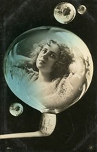 Woman reflected in a bubble, postcard, c1890-c1909(?). Artist: Unknown