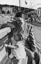 Adolf Hitler and Helga Goebbels, 1936. Artist: Unknown