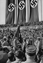 Adolf Hitler dedicates new standards, Nuremberg Rally, Germany, 1934. Artist: Unknown