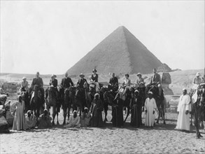 Camel tour in front of one of the Pyramids of Giza, Egypt, c1920s-c1930s(?). Artist: Unknown