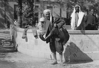 A water carrier in Damascus, Syria, c1920s-c1930s(?). Artist: Unknown