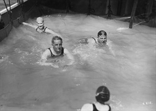 Passengers in the swimming pool on board a cruise ship, c1920s-c1930s(?). Artist: Unknown