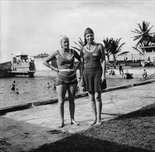 Two women in swimsuits beside a swimming pool, Balboa, Panama, 1931. Artist: Unknown