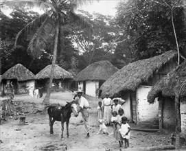Family outside their home, Coolie Street, Kingston, Jamaica, 1931. Artist: Unknown